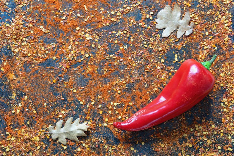 Autumn Spicy Background. Crushed Hot Paprika on Black Surface Stock
