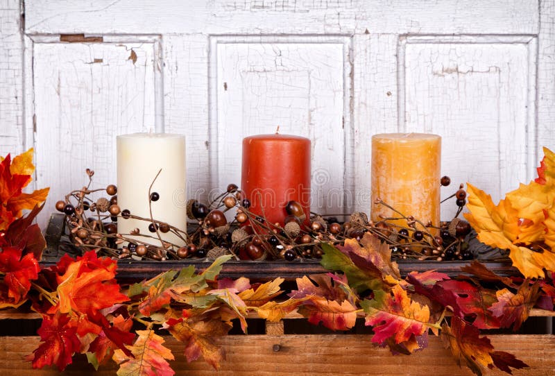 Autumn still life with candles and leaves