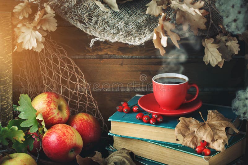 Autumn still life with a cup of coffee, apples and autumn leaves. Autumn background. Board, interior.