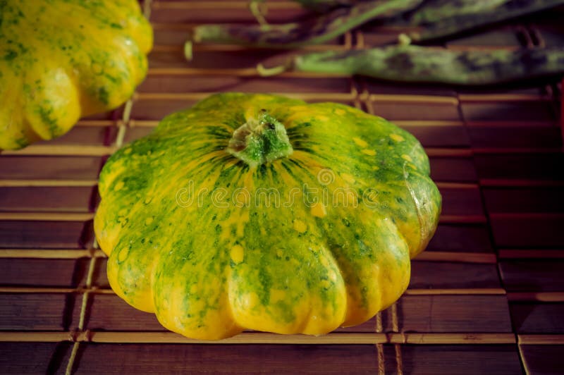 Autumn still life - small spotted squash, asparagus beans, purple Basil, paprika on bamboo Mat royalty free stock image Autumn still life - small spotted squash, asparagus beans, purple Basil, paprika on bamboo Mat royalty free stock image