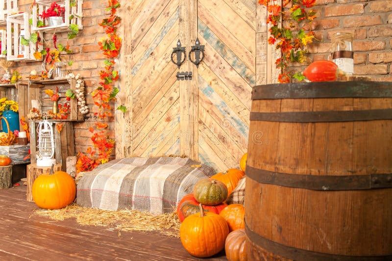 Pumpkins, autumn, barrel, lamp, straw, wooden door on the background stock images Pumpkins, autumn, barrel, lamp, straw, wooden door on the background stock images