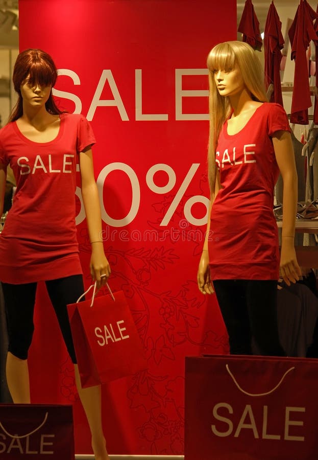 Shop window with 2 mannequins and SALE information. Shop window with 2 mannequins and SALE information