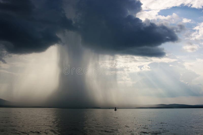 Thunderstorm cloudburst. The effective sky and lake. Thunderstorm cloudburst. The effective sky and lake