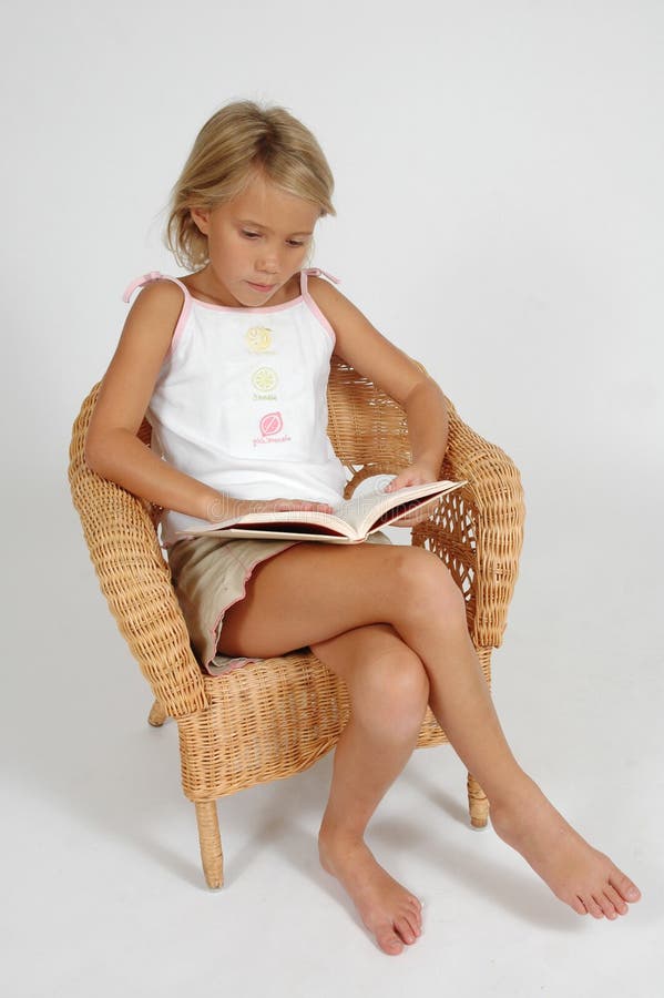 Read: to look at carefully so as to understand the meaning of. Child reading a book in a chair isolated on white background. Reading broadens the mind. Read: to look at carefully so as to understand the meaning of. Child reading a book in a chair isolated on white background. Reading broadens the mind.