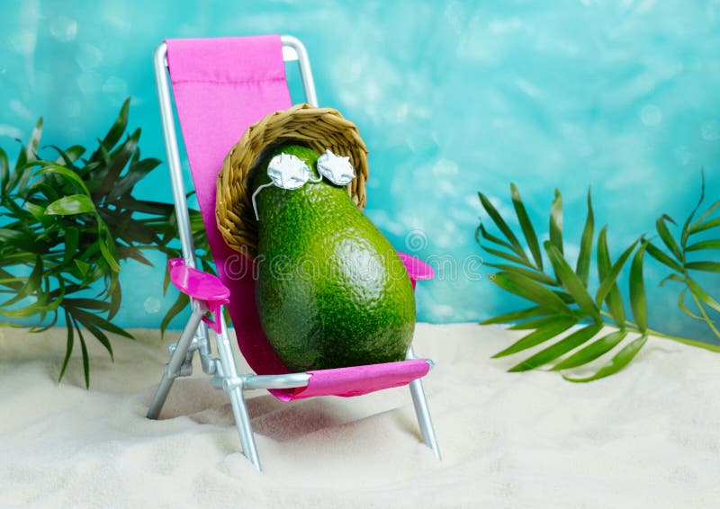 Avocado in hat and sunglasses  relaxes on  lounge chair on  beach. Summer tropical minimal humor poster