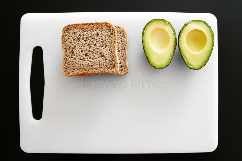 Sandwiches Made of Avocado and Dark Bread.Avocado on a Plate. White