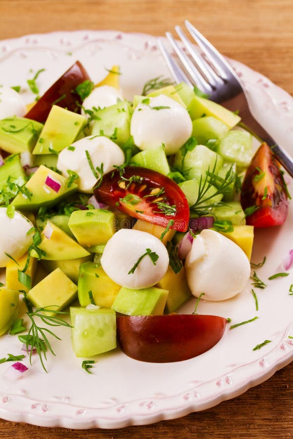 Avocado Salad with Tomato, Cucumber and Mozzarella. Cheese and
