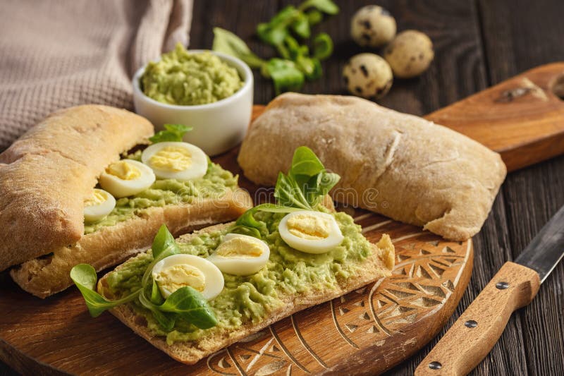 Avocado Sandwich Ciabatta with Quail Eggs. Stock Photo Image of