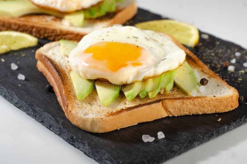 Avocado Sandwich with Fried Egg Sliced Avocado and Egg on Toasted
