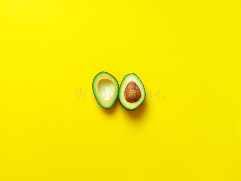 Avocado sliced with seed in yellow royalty free stock photos Avocado sliced with seed in yellow royalty free stock photos
