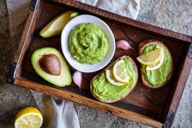 Avocado spread with garlic on wholewheat slice of bread