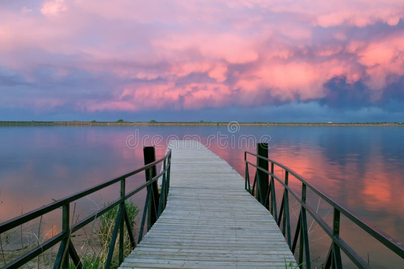 Awesome clouds over a fishing pier at sunset