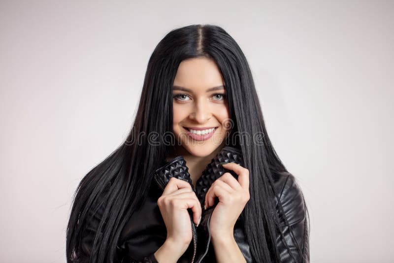 Awesome Dark Haired Model Holding The Collar Of Black Leather Jacket