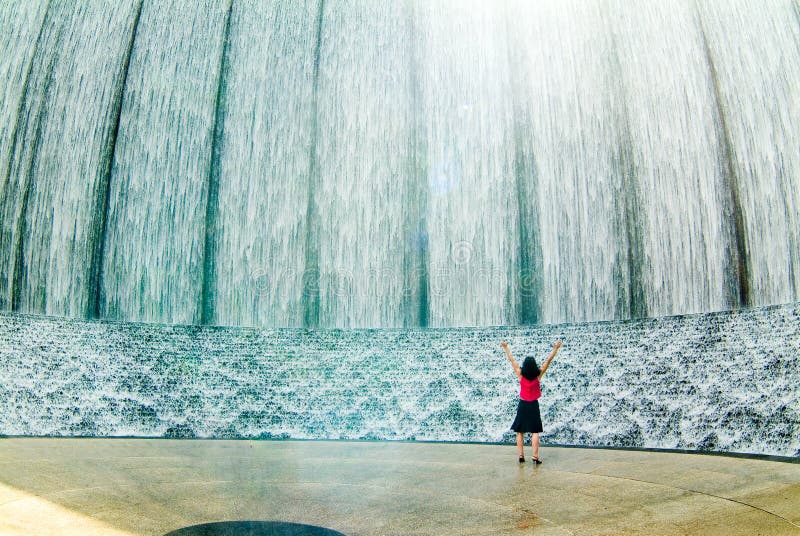 Awestruck woman at fountain with arms raised. Full growth confident stock images, royalty-free photos and pictures