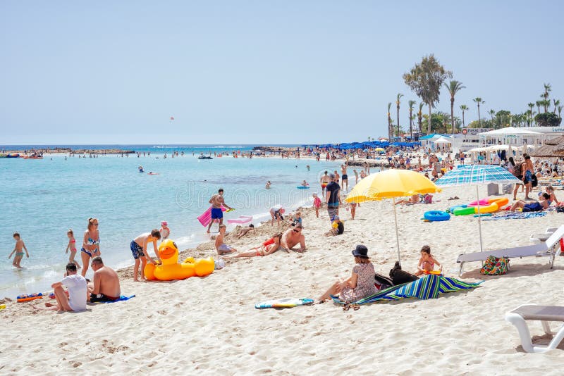 Ayia Napa, Cyprus - July 04, 2018: Tourists and locals enjoying the summer vacations on the Nissi beach stock photo Ayia Napa, Cyprus - July 04, 2018: Tourists and locals enjoying the summer vacations on the Nissi beach stock photo