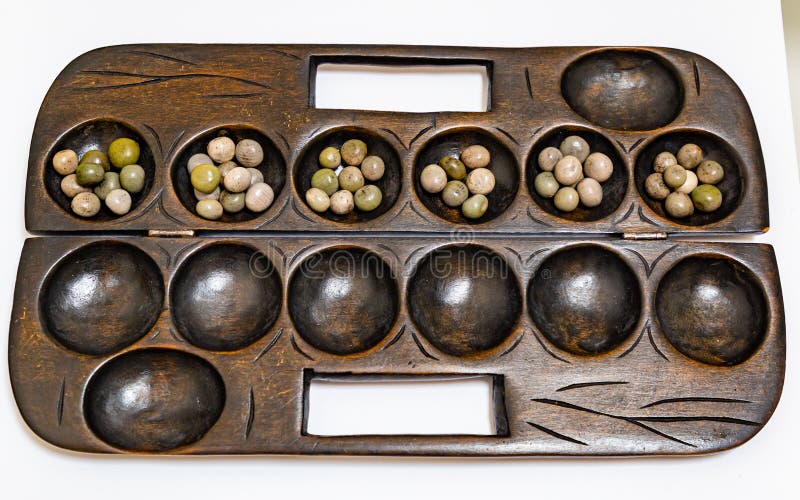 Ayo Olopon. Some call it Mancala. A Yoruba Nigerian brain game.