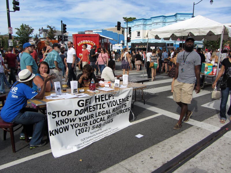 Photo of domestic violence stand at the h street festival in downtown washington dc on 9/15/12. This festival takes place every year in mid september with food, arts and crafts, music, a parade, car displays, free health screenings and dance. The h street neighborhood is undergoing revitalization. Photo of domestic violence stand at the h street festival in downtown washington dc on 9/15/12. This festival takes place every year in mid september with food, arts and crafts, music, a parade, car displays, free health screenings and dance. The h street neighborhood is undergoing revitalization.