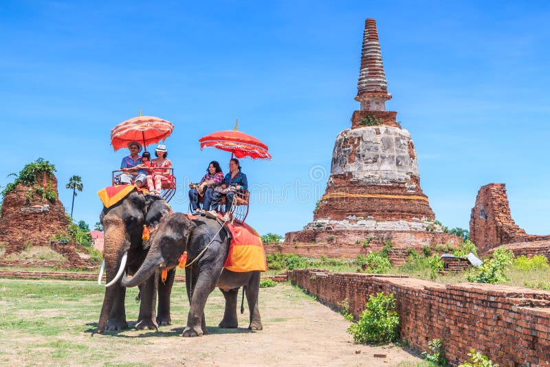 AYUTTHAYA, THAILAND - JUNE 1: Tourists on an elephant ride tour