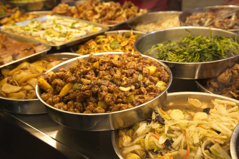 Various platters and bowls filled with traditional Asian food. Various platters and bowls filled with traditional Asian food.