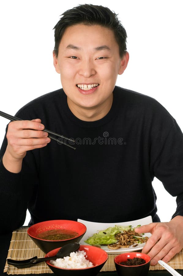 Young men eats asian food, isolated on a white background. Young men eats asian food, isolated on a white background.