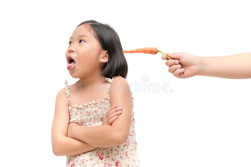 Asian child girl with expression of disgust against vegetables isolated on white background, Refusing food concept. Asian child girl with expression of disgust against vegetables isolated on white background, Refusing food concept