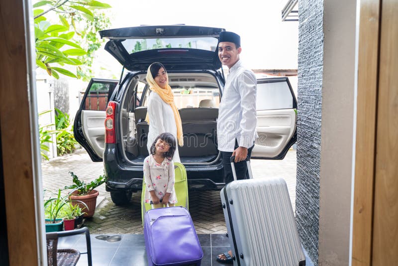 Asian muslim family with suitcase prepare to go. concept of family travelling for eid mubarak celebration. Asian muslim family with suitcase prepare to go. concept of family travelling for eid mubarak celebration