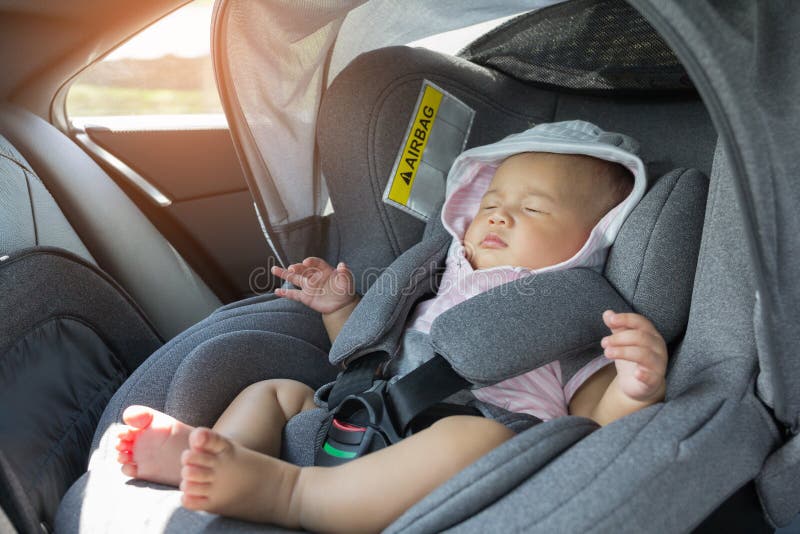Asian cute newborn baby sleeping in modern car seat. Child new born traveling safety on the road. Safe way to travel fastened seat belts in a vehicle with young kids. Trip with an infant. Asian cute newborn baby sleeping in modern car seat. Child new born traveling safety on the road. Safe way to travel fastened seat belts in a vehicle with young kids. Trip with an infant.