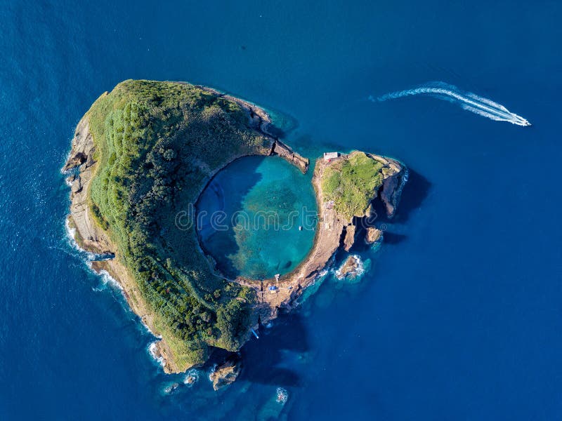 Azores aerial panoramic view. Top view of Islet of Vila Franca do Campo. Crater of an old underwater volcano. San Miguel island, Azores, Portugal. Heart carved by nature. Bird eye view