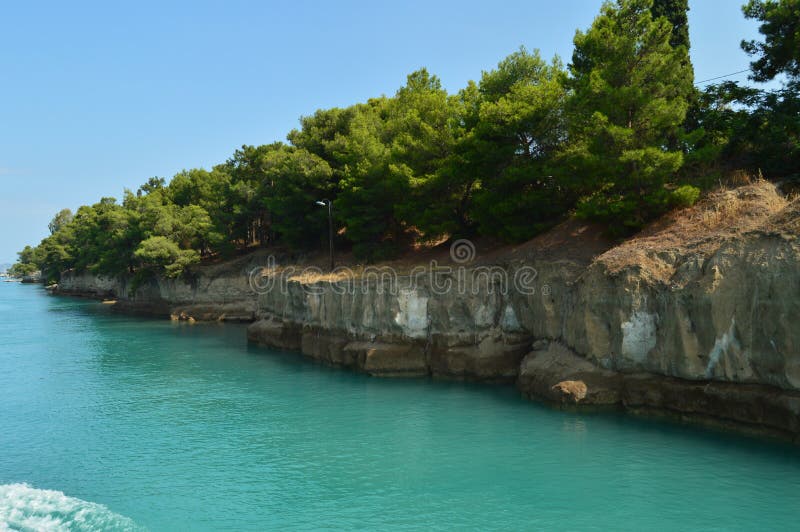 Nice Greenish Blue Tone Of The Sea United To The Molten Limestone Rock In Some Beautiful Rays Of Sun By Canal De Corinto. Architecture, Travel, Landscapes. July 8, 2018. Corinth Canal Peloponnese Greece. Nice Greenish Blue Tone Of The Sea United To The Molten Limestone Rock In Some Beautiful Rays Of Sun By Canal De Corinto. Architecture, Travel, Landscapes. July 8, 2018. Corinth Canal Peloponnese Greece.