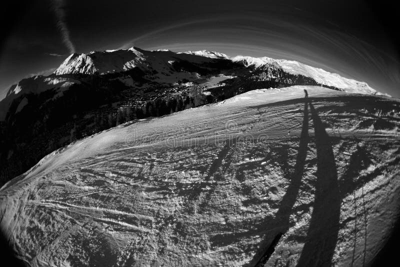 Skiing at its best. Fisheye shot taken in the middle of the slope, showing skier, slope, and vista. Skiing at its best. Fisheye shot taken in the middle of the slope, showing skier, slope, and vista.