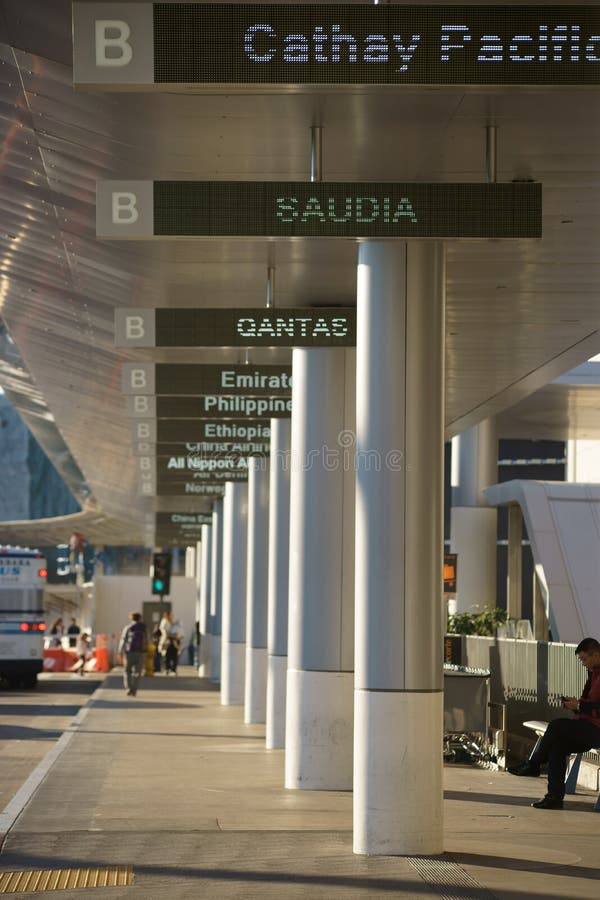 Los Angeles, United States - December 28, 2015: The walkway with digital displays of individual countries on Tom Bradley departure terminal for international flights at the airport LAX on December 28, 2015 in Los Angeles. Los Angeles, United States - December 28, 2015: The walkway with digital displays of individual countries on Tom Bradley departure terminal for international flights at the airport LAX on December 28, 2015 in Los Angeles.