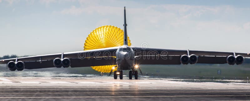 American USAF B52 stratofortress landing on runway with deployed parachute, RAF Fairford, England, UK. American USAF B52 stratofortress landing on runway with deployed parachute, RAF Fairford, England, UK.