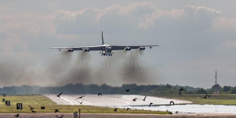 American USAF B52 stratofotress over runway after practicing a touch and go manoeuvre, RAF Fairford, England. Bird strike danger. American USAF B52 stratofotress over runway after practicing a touch and go manoeuvre, RAF Fairford, England. Bird strike danger.