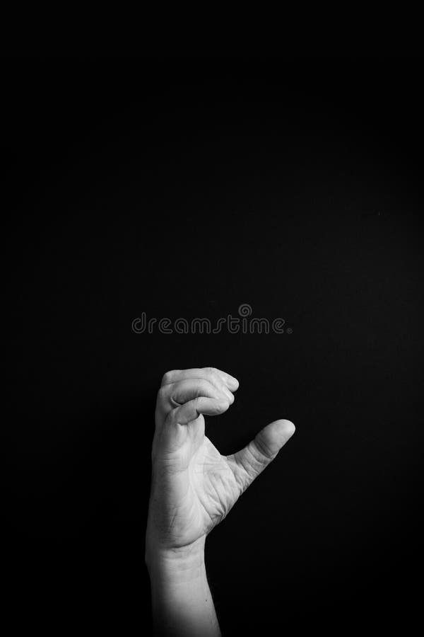 B&W image of hand demonstrating ASL sign language letter C with empty copy space royalty free stock images