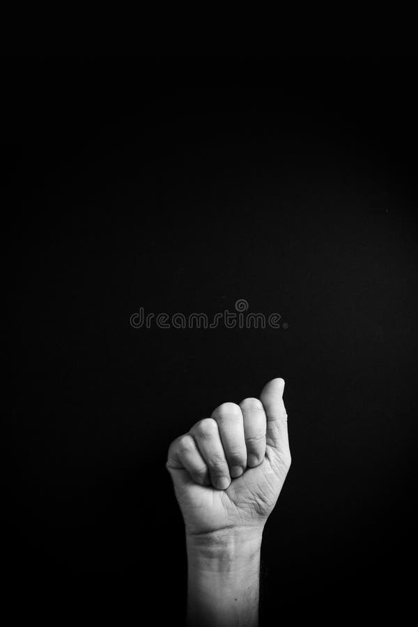 B&W image of hand demonstrating ASL sign language letter A with empty copy space royalty free stock photos