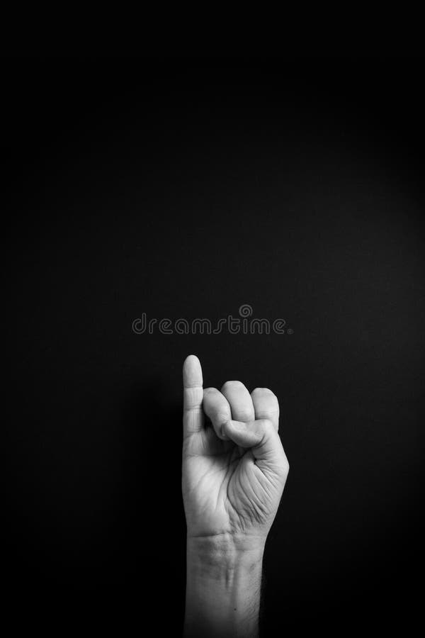 B&W image of hand demonstrating ASL sign language letter I with empty copy space royalty free stock images