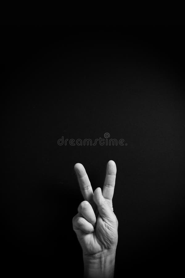 B&W image of hand demonstrating ASL sign language letter K with empty copy space royalty free stock image