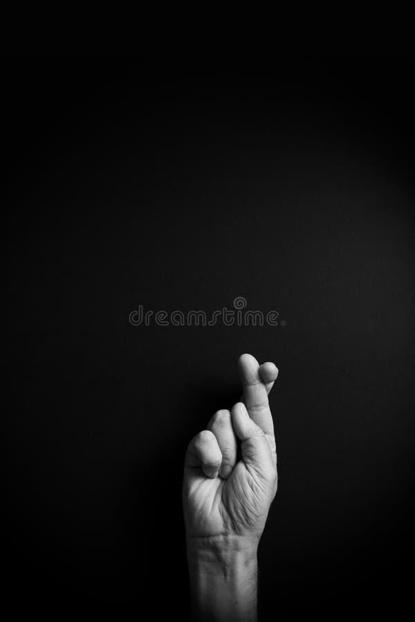 B&W image of hand demonstrating ASL sign language letter R with empty copy space royalty free stock image