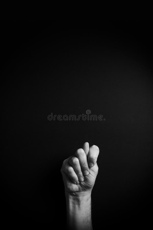B&W image of hand demonstrating ASL sign language letter T with empty copy space stock photography