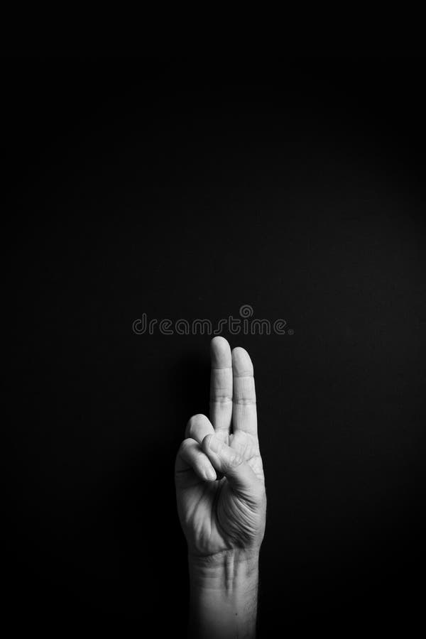 B&W image of hand demonstrating ASL sign language letter U with empty copy space stock photo