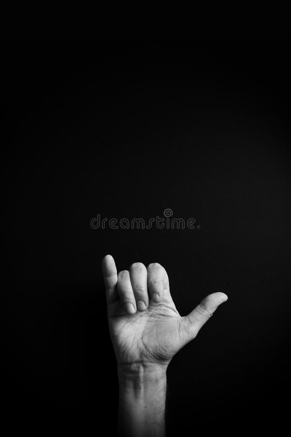 B&W image of hand demonstrating ASL sign language letter Y with empty copy space stock image