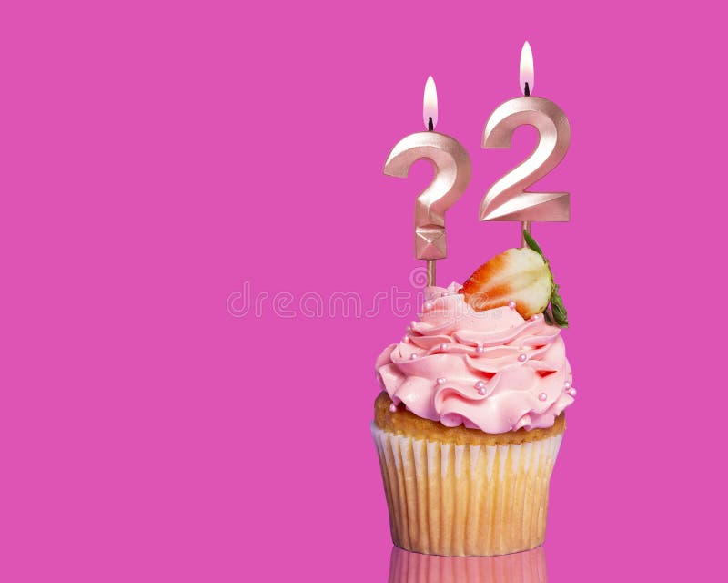 Birthday Cupcake With Candle Question Mark And Number 2 - On Hot Pink Background. Birthday Cupcake With Candle Question Mark And Number 2 - On Hot Pink Background.