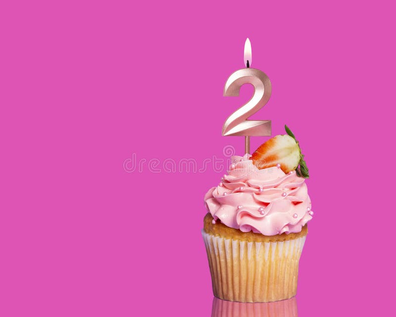 Birthday Cupcake With Candle Number 2 - On Hot Pink Background. Birthday Cupcake With Candle Number 2 - On Hot Pink Background.