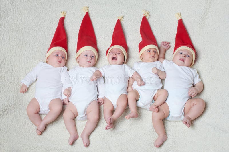 Babies with santa hats on bright background stock images Babies with santa hats on bright background stock images