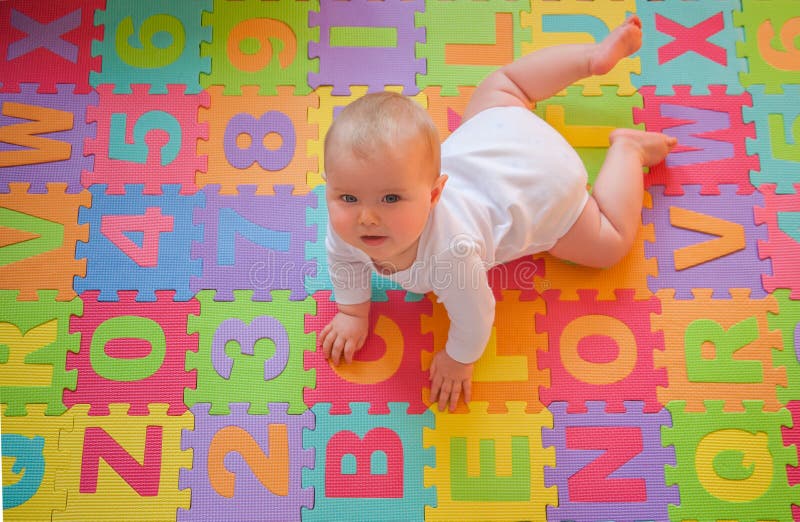 Baby on alphabet mat stock photography Baby on alphabet mat stock photography
