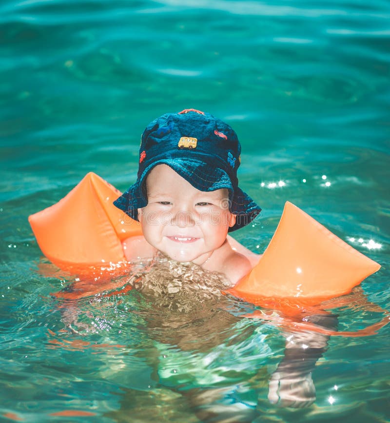 Baby with armbands stock image. Image of playful, baby 58516163