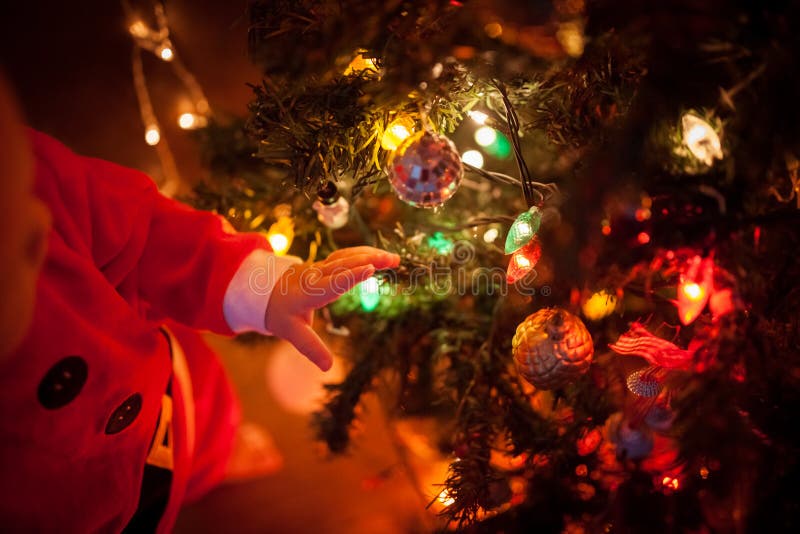 The Baby Around the Christmas Tree with Lights Stock Photo Image of