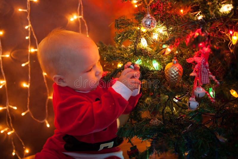 The Baby Around the Christmas Tree with Lights Stock Photo Image of