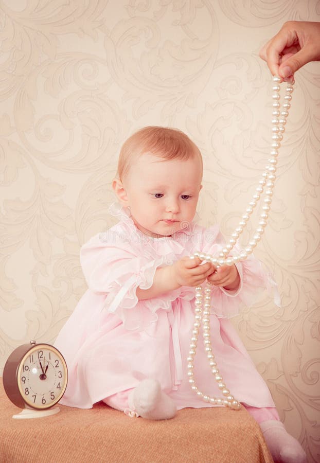 The Baby Around the Clock on a Background Stock Photo Image of