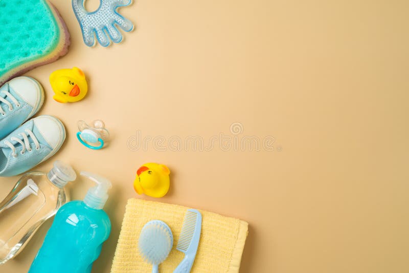 Baby bath and children health care products on modern background. Infant shampoo, duck toys and towel. Top view, flat lay stock photos